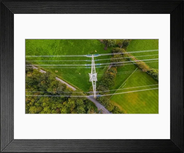 Framed Print : A man made steel tower with power lines in the middle of nature, trees and meadows in Germany Framed Print : A man made steel tower with power lines in the middle of nature, trees and meadows in Germany