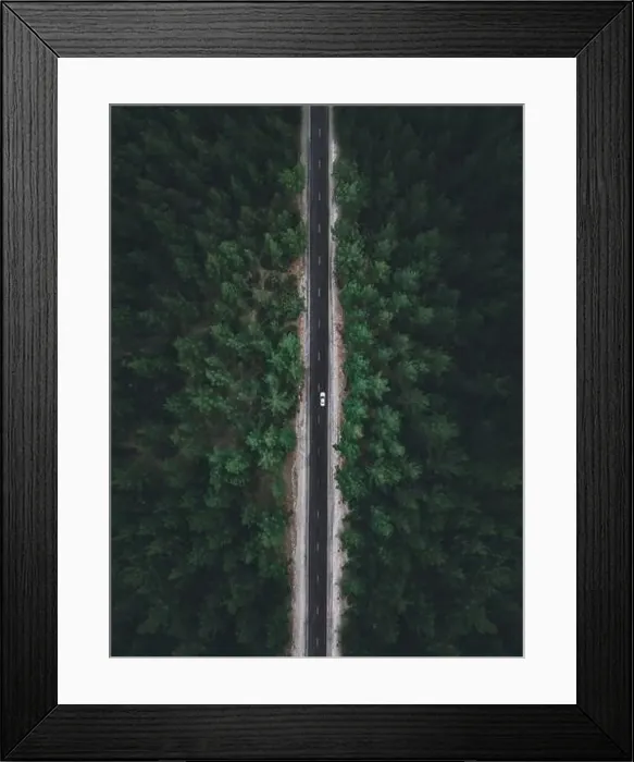 Framed Print : Aerial view taken by drone of a car driving on a forest road in autumn Framed Print : Aerial view taken by drone of a car driving on a forest road in autumn