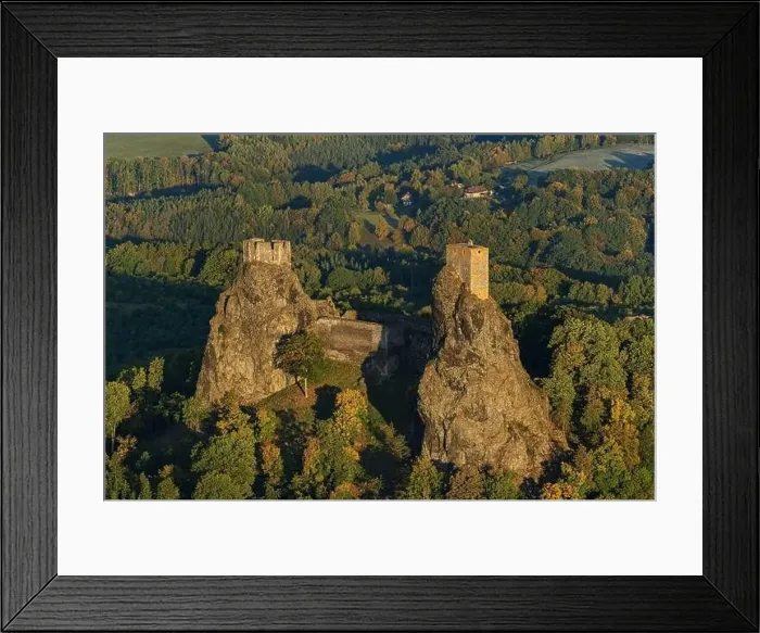 Framed Print : Aerial view of ancient ruined Trosky Castle high on summits of two basalt volcanic plugs on background of autumn Framed Print : Aerial view of ancient ruined Trosky Castle high on summits of two basalt volcanic plugs on background of autumn