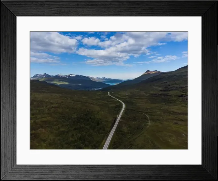 Framed Print : Winding road in a high valley in Norway, clouds and high mountains. Taiga and arctic feeling Framed Print : Winding road in a high valley in Norway, clouds and high mountains. Taiga and arctic feeling