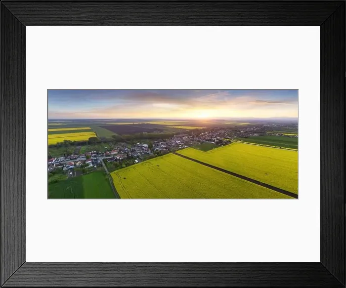 Framed Print : Nice aerial sunset landscape over yellow - green fields with rural village Framed Print : Nice aerial sunset landscape over yellow - green fields with rural village