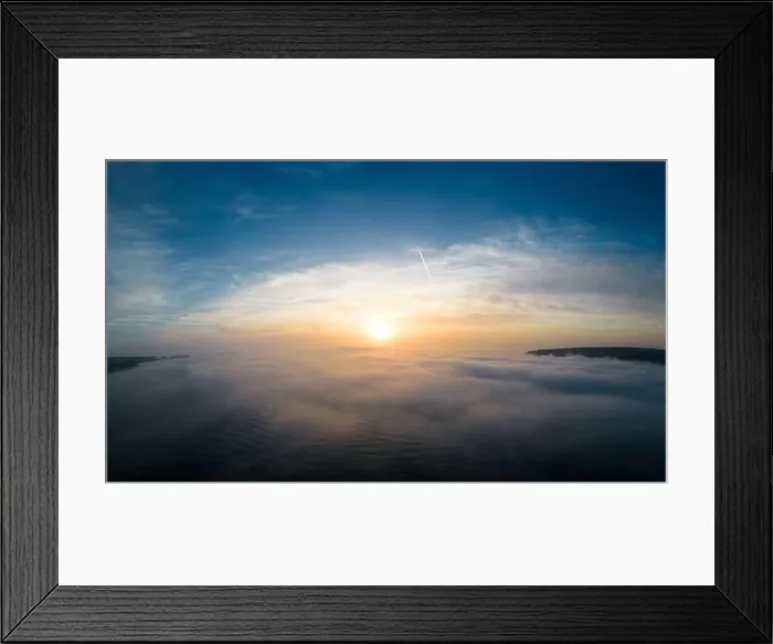 Framed Print : Aerial view of a sunrise sea with a blanket of morning fog and morning sunbeams shining through Framed Print : Aerial view of a sunrise sea with a blanket of morning fog and morning sunbeams shining through