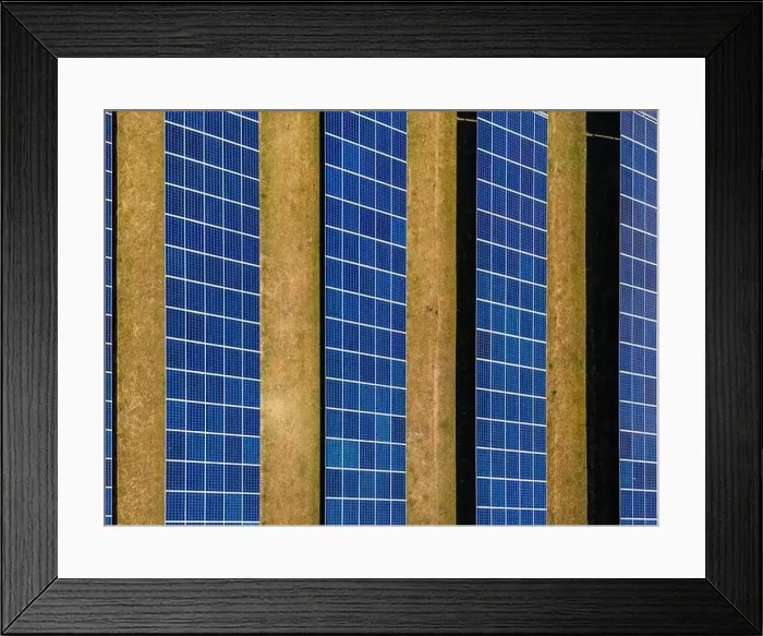 Framed Print : Aerial view of solar modules of a ground-mounted photovoltaic system on a field as a top view from above