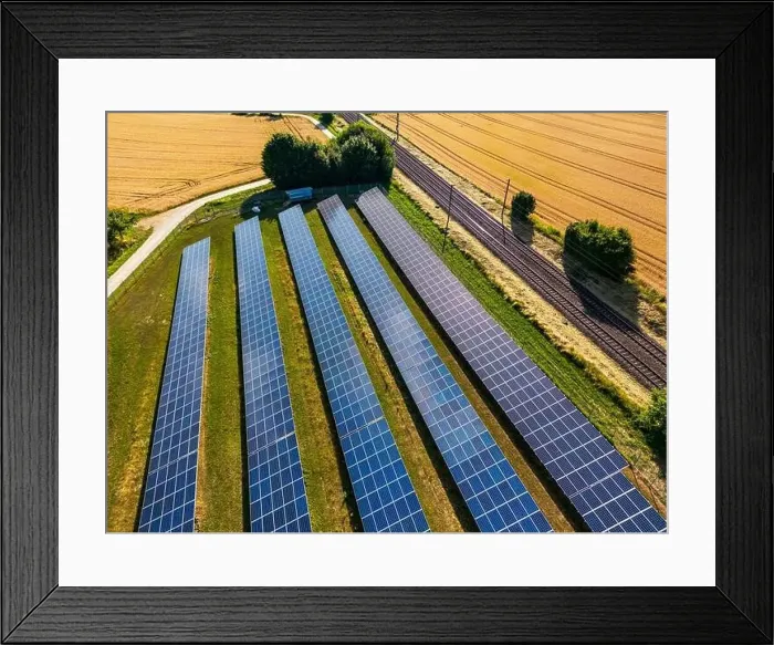 Framed Print : Ground-mounted system with solar cells and solar modules in the countryside next to a railroad line Framed Print : Ground-mounted system with solar cells and solar modules in the countryside next to a railroad line