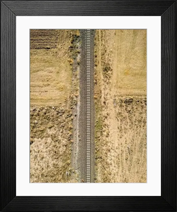 Framed Print : Top view of the train track passing through the arid land, taken with a drone Framed Print : Top view of the train track passing through the arid land, taken with a drone