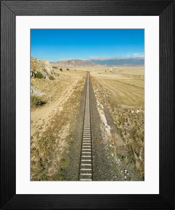 Framed Print : Top view of the train track passing through the arid land, taken with a drone Framed Print : Top view of the train track passing through the arid land, taken with a drone