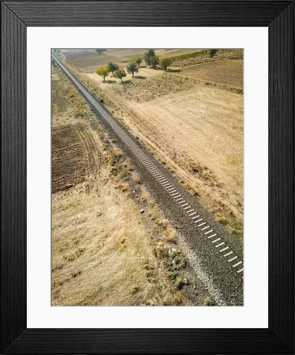 Framed Print : Top view of the train track passing through the arid land, taken with a drone Framed Print : Top view of the train track passing through the arid land, taken with a drone