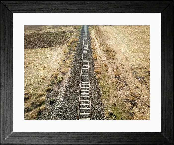 Framed Print : Top view of the train track passing through the arid land, taken with a drone Framed Print : Top view of the train track passing through the arid land, taken with a drone