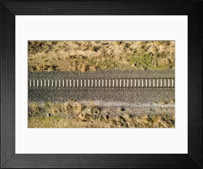 Framed Print : Top view of the train track passing through the arid land, taken with a drone Framed Print : Top view of the train track passing through the arid land, taken with a drone