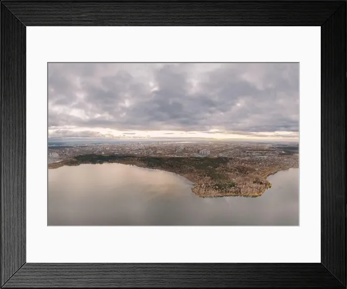 Framed Print : Autumn forest on lake shore at sunset and city on horizon, aerial view. Lake Shartash and Yekaterinburg, Russia Framed Print : Autumn forest on lake shore at sunset and city on horizon, aerial view. Lake Shartash and Yekaterinburg, Russia