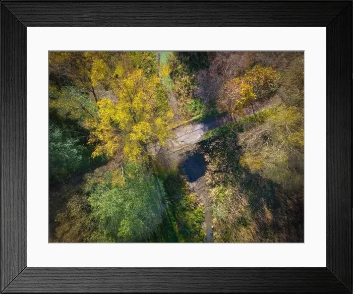 Framed Print : Aerial view of a rural road with in yellow and orange autumn forest Framed Print : Aerial view of a rural road with in yellow and orange autumn forest