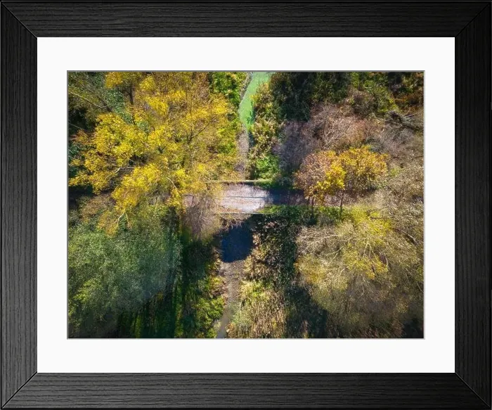 Framed Print : Aerial view of a rural road with in yellow and orange autumn forest Framed Print : Aerial view of a rural road with in yellow and orange autumn forest