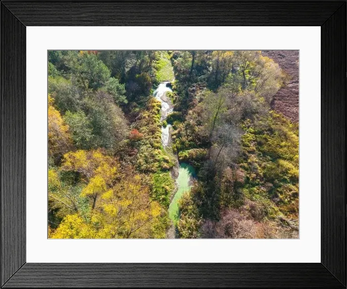 Framed Print : Aerial view of a rural road with in yellow and orange autumn forest Framed Print : Aerial view of a rural road with in yellow and orange autumn forest