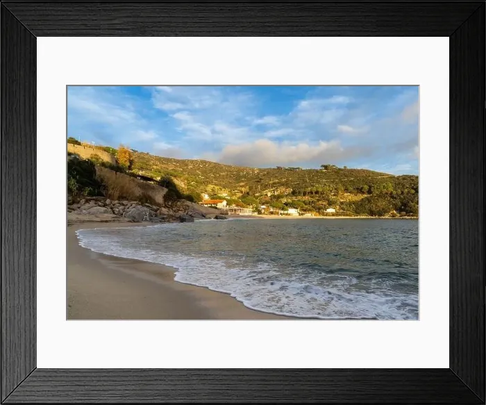 Framed Print : A landscape view of Cavoli Beach on Elba in warm evening light and boulders in the foreground Framed Print : A landscape view of Cavoli Beach on Elba in warm evening light and boulders in the foreground