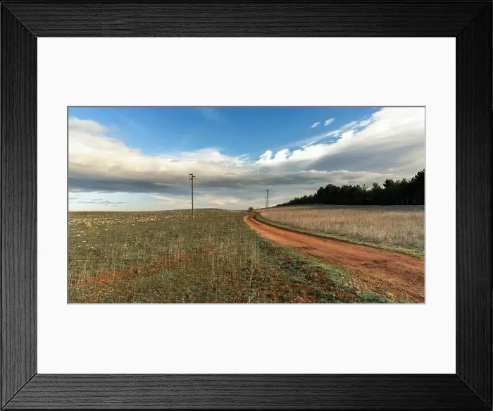 Framed Print : A red dirt road leading through the barren limestone fields of the Alta murgia Naitonal Park in southern Italy Framed Print : A red dirt road leading through the barren limestone fields of the Alta murgia Naitonal Park in southern Italy