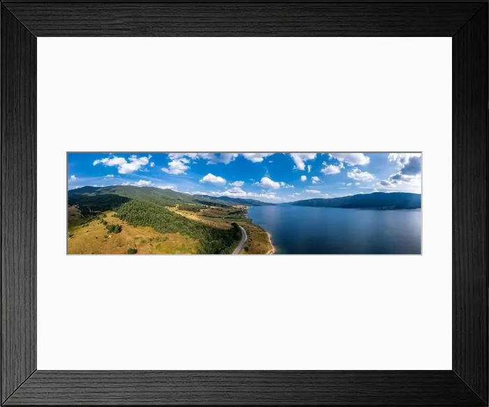 Framed Print : Spectacular aerial view from a drone to a lake, hills, and a road between Framed Print : Spectacular aerial view from a drone to a lake, hills, and a road between