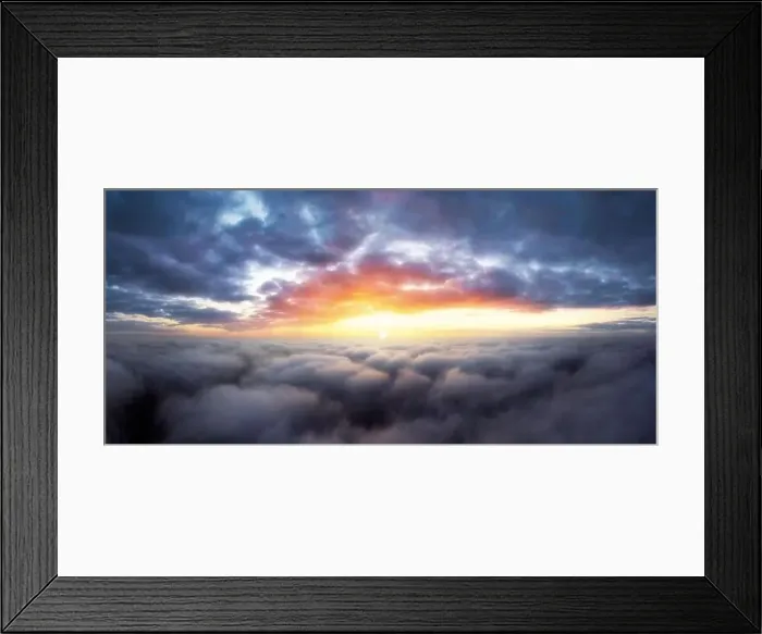 Framed Print : Dramatic sunrise sky above fluffy clouds early in the morning from aerial drone view