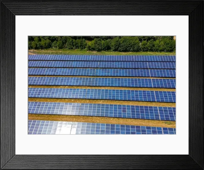 Framed Print : Solar power plant with rows of photovoltaic modules in a rural area next to a forest, Germany Framed Print : Solar power plant with rows of photovoltaic modules in a rural area next to a forest, Germany