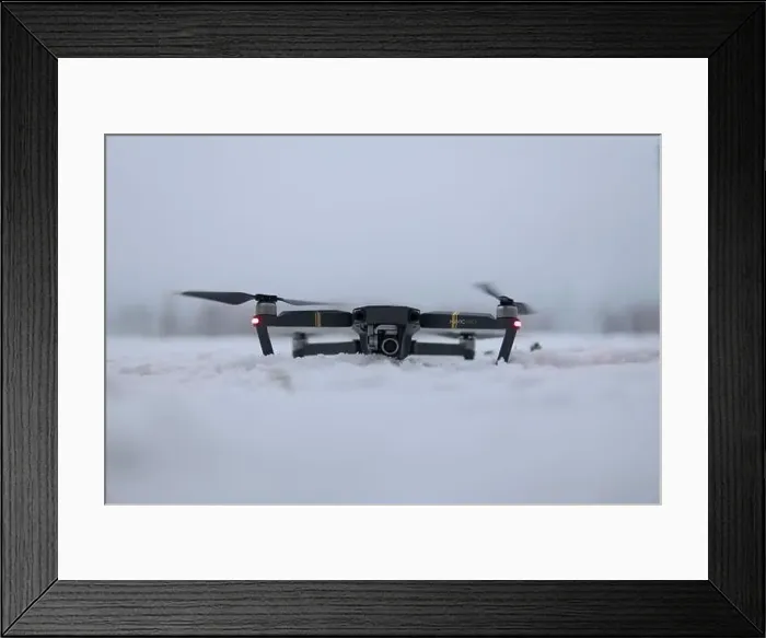Framed Print : Drone Ready for Takeoff on Snowy Ground in Winter Landscape Framed Print : Drone Ready for Takeoff on Snowy Ground in Winter Landscape