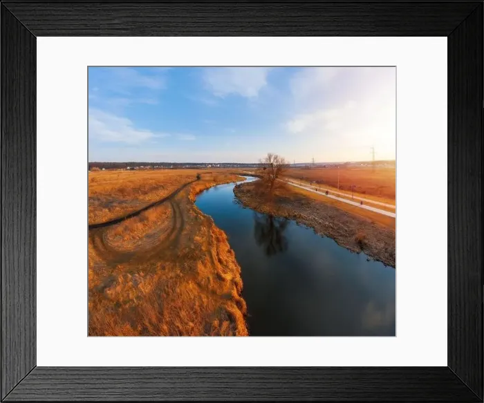 Framed Print : Winding river in field with dry grass Framed Print : Winding river in field with dry grass