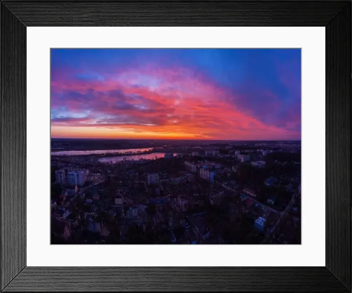 Framed Print : Aerial view of dramatic sunset sky with clouds above the city at dusk Framed Print : Aerial view of dramatic sunset sky with clouds above the city at dusk