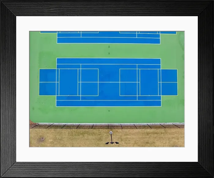 Framed Print : Aerial photo of unusually painted outdoor blue tennis courts with yellow pickleball lines and green out of bounds area Framed Print : Aerial photo of unusually painted outdoor blue tennis courts with yellow pickleball lines and green out of bounds area