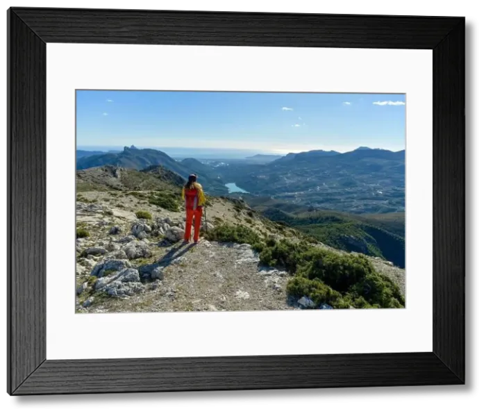 Framed Print : A woman standing on a rocky point overlooking Mediterranean sea Framed Print : A woman standing on a rocky point overlooking Mediterranean sea