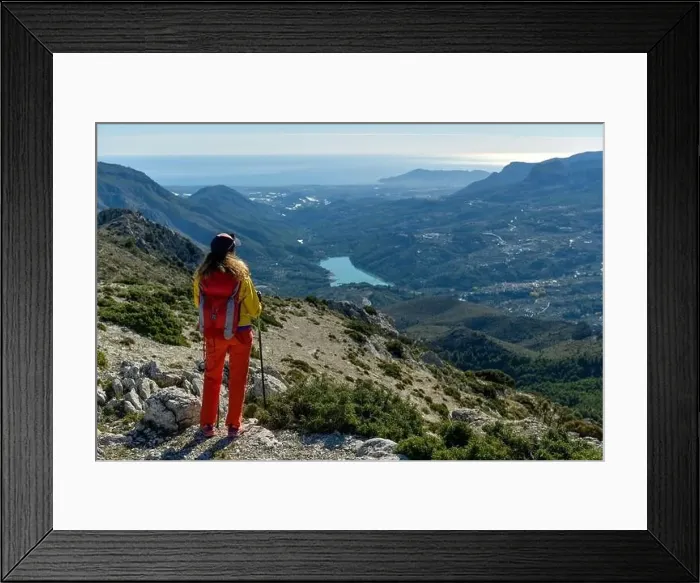 Framed Print : A woman standing on a rocky point overlooking Mediterranean sea Framed Print : A woman standing on a rocky point overlooking Mediterranean sea