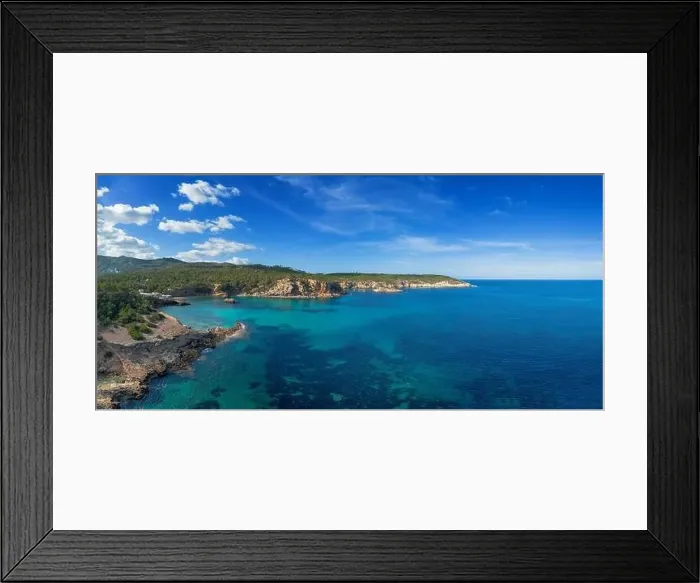 Framed Print : aerial view the green and rugged hilly coast of northern Ibiza with the turquoise waters of Cala Xarraca bay Framed Print : aerial view the green and rugged hilly coast of northern Ibiza with the turquoise waters of Cala Xarraca bay
