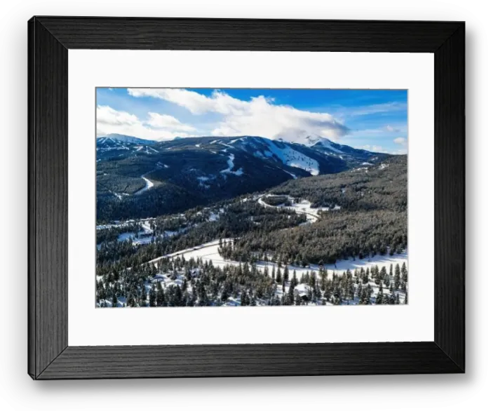 Framed Print : Aerial view traffic road through the snowy mountains with pine trees Framed Print : Aerial view traffic road through the snowy mountains with pine trees