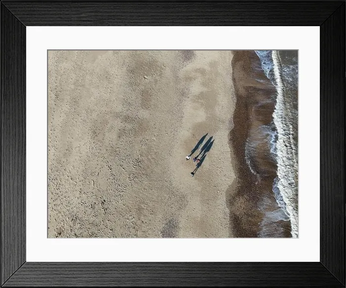 Framed Print : Overhead birds eye drone aerial view people walking on beach long shadows Great Yarmouth beach Framed Print : Overhead birds eye drone aerial view people walking on beach long shadows Great Yarmouth beach