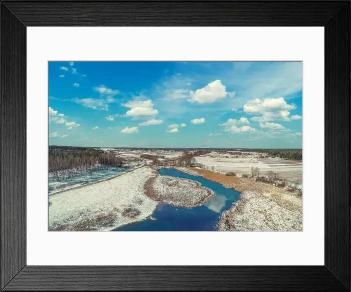 Framed Print : Aerial view of the winding river in early spring. Snow lies on dry reeds Framed Print : Aerial view of the winding river in early spring. Snow lies on dry reeds