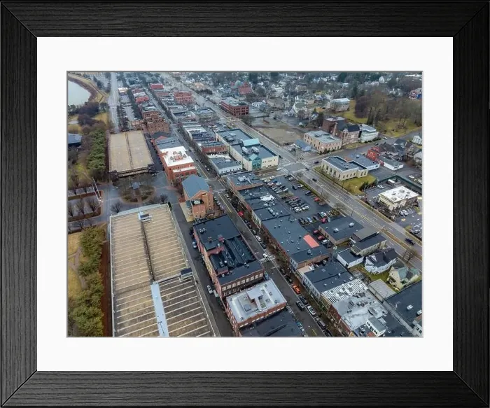 Framed Print : Corning, NY, USA - 03-02-2024 - Cloudy winter aerial image of the downtown area in the City of Corning Framed Print : Corning, NY, USA - 03-02-2024 - Cloudy winter aerial image of the downtown area in the City of Corning