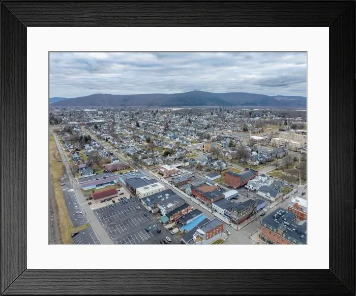 Framed Print : Sayre, PA, USA - 03-03-2024 - Cloudy winter aerial image of the downtown area in the City of Sayre, PA