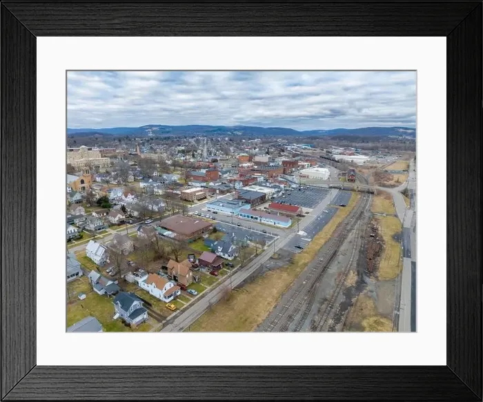 Framed Print : Sayre, PA, USA - 03-03-2024 - Cloudy winter aerial image of the downtown area in the City of Sayre, PA