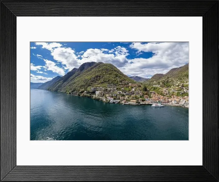Framed Print : Aerial view of Argegno, idyllic village on Lake Como, Lombardy, Italy. Ferry boat loading passengers waiting to leave Framed Print : Aerial view of Argegno, idyllic village on Lake Como, Lombardy, Italy. Ferry boat loading passengers waiting to leave