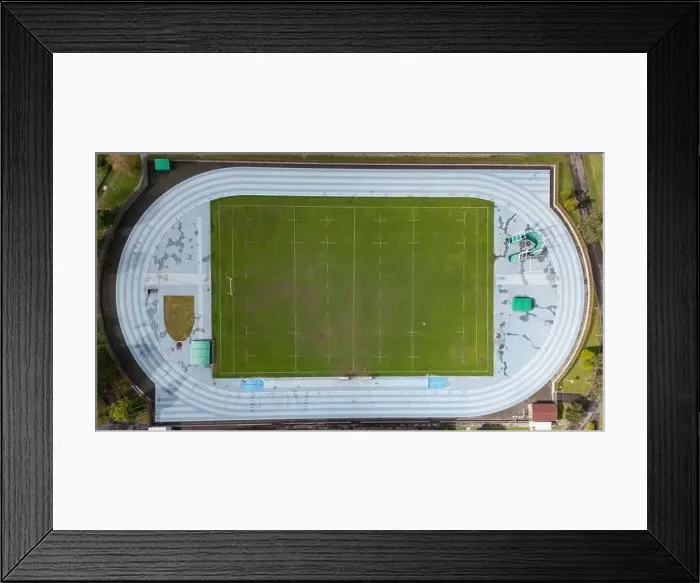 Framed Print : Drone shot capturing the top-down view of a sports complex featuring a track, a field, and surrounding facilities Framed Print : Drone shot capturing the top-down view of a sports complex featuring a track, a field, and surrounding facilities