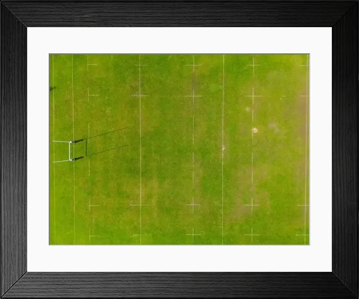 Framed Print : An aerial shot captured by a drone showcasing a detailed perspective of a lush green sports field Framed Print : An aerial shot captured by a drone showcasing a detailed perspective of a lush green sports field