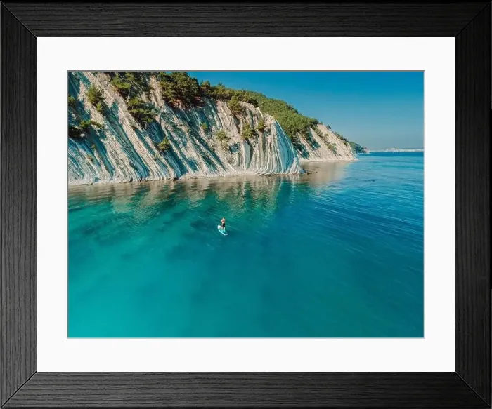 Framed Print : Man on stand up paddle board in blue sea in Mediterranean sea with scenic landscape. Aerial view Framed Print : Man on stand up paddle board in blue sea in Mediterranean sea with scenic landscape. Aerial view