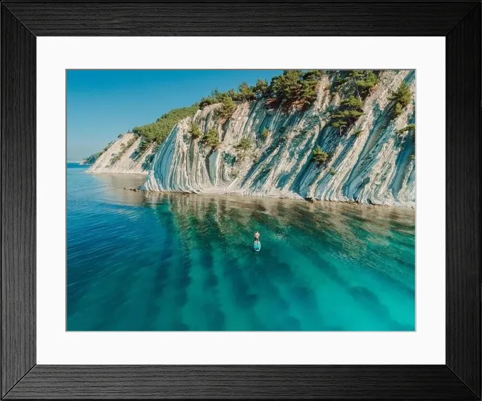Framed Print : SUP boarding in Mediterranean sea with mountain coastline. Aerial view Framed Print : SUP boarding in Mediterranean sea with mountain coastline. Aerial view
