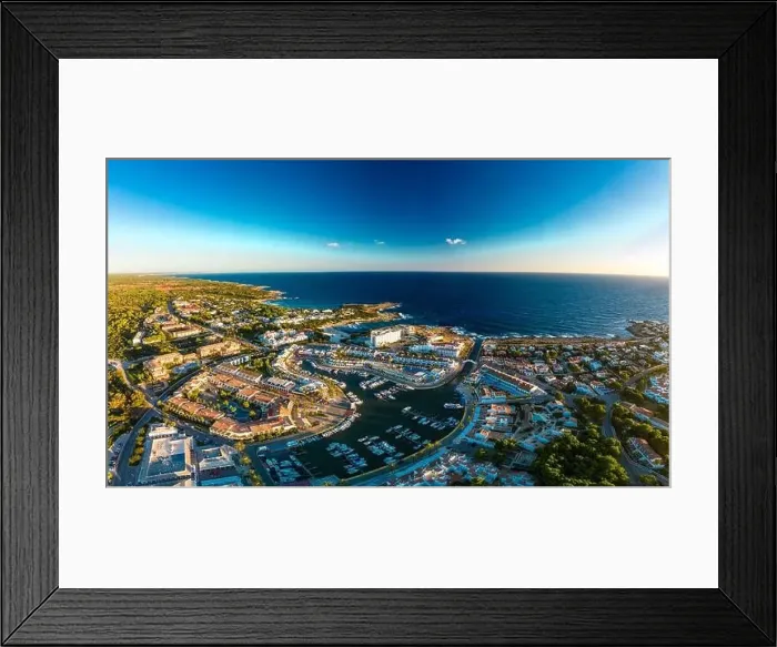 Framed Print : Aerial drone view of the harbor, housing and the beach of Cala en Bosc on the Spanish island of Menorca Framed Print : Aerial drone view of the harbor, housing and the beach of Cala en Bosc on the Spanish island of Menorca