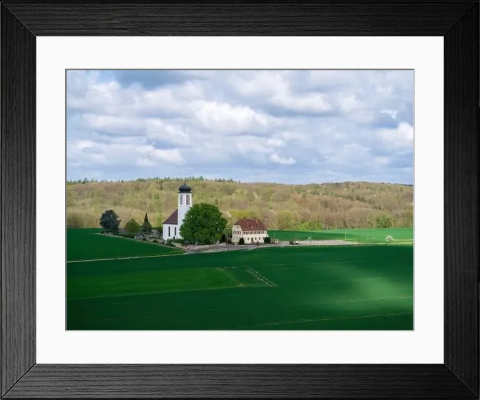 Framed Print : Small church with cemetery in the middle of blooming fruit trees and fields captured with a drone in spring Framed Print : Small church with cemetery in the middle of blooming fruit trees and fields captured with a drone in spring