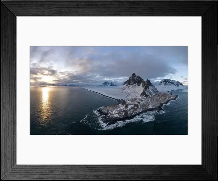Framed Print : Majestic aerial view of a snow-covered mountainous peninsula in Iceland during sunset with glimmering sea Framed Print : Majestic aerial view of a snow-covered mountainous peninsula in Iceland during sunset with glimmering sea