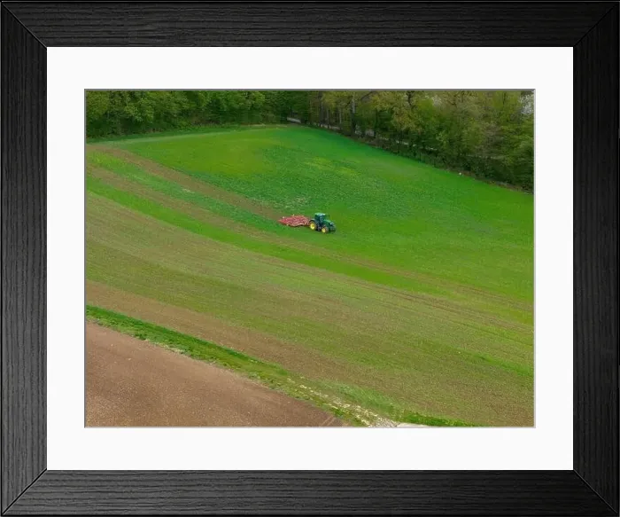 Framed Print : Tractor with cultivator in a field with small plants captured with a drone Framed Print : Tractor with cultivator in a field with small plants captured with a drone