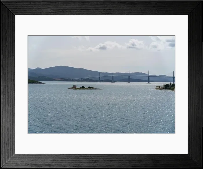 Framed Print : A serene landscape featuring a vast reservoir of water with a bridge in the background Framed Print : A serene landscape featuring a vast reservoir of water with a bridge in the background
