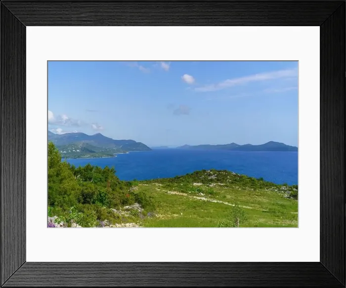 Framed Print : A serene lake reflects the sky and surrounding mountains in the background Framed Print : A serene lake reflects the sky and surrounding mountains in the background