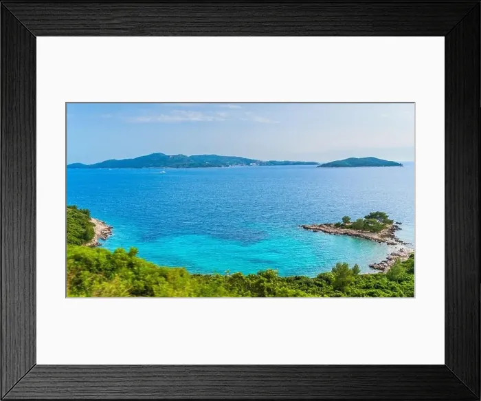Framed Print : A picturesque lake with a small island in the center Framed Print : A picturesque lake with a small island in the center