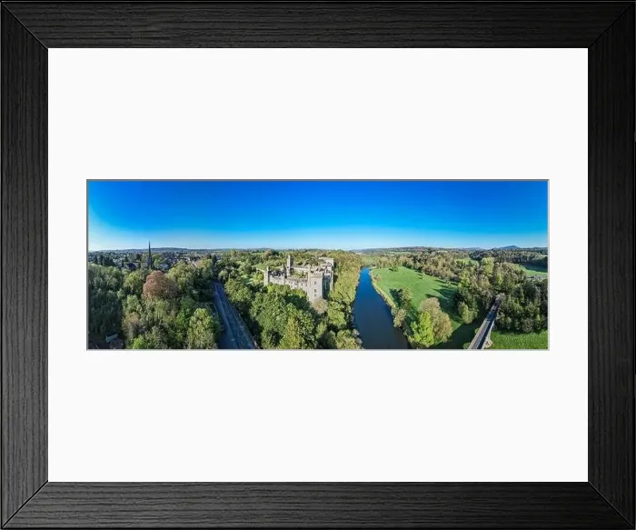 Framed Print : An aerial panorama reveals the majestic Lismore Castle in County Waterford, Ireland, set against a flawless spring sky