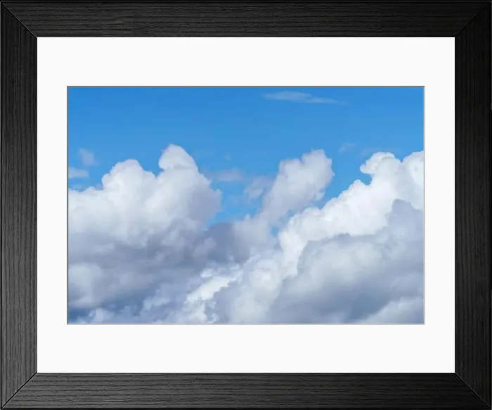 Framed Print : The electric blue sky is adorned with fluffy white cumulus clouds Framed Print : The electric blue sky is adorned with fluffy white cumulus clouds