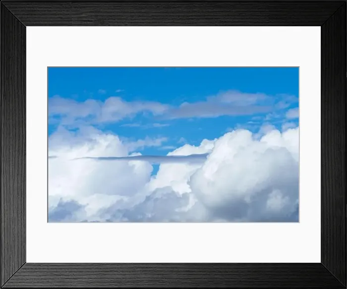 Framed Print : The electric blue sky is adorned with fluffy white cumulus clouds Framed Print : The electric blue sky is adorned with fluffy white cumulus clouds